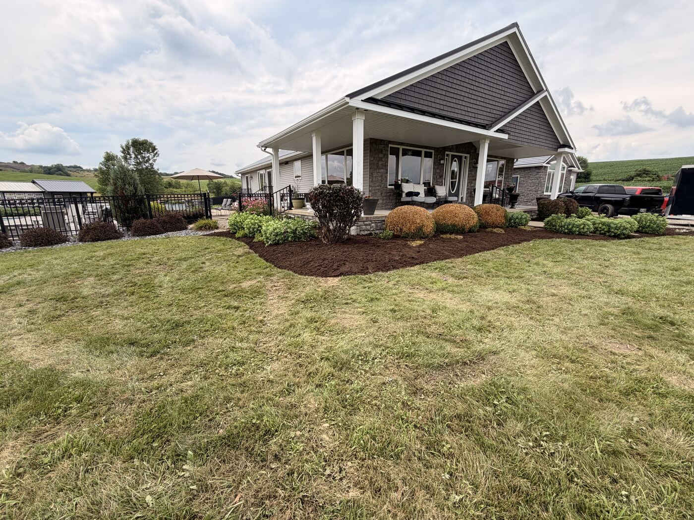 Front yard landscape bed with trimmed shrubs and fresh mulch