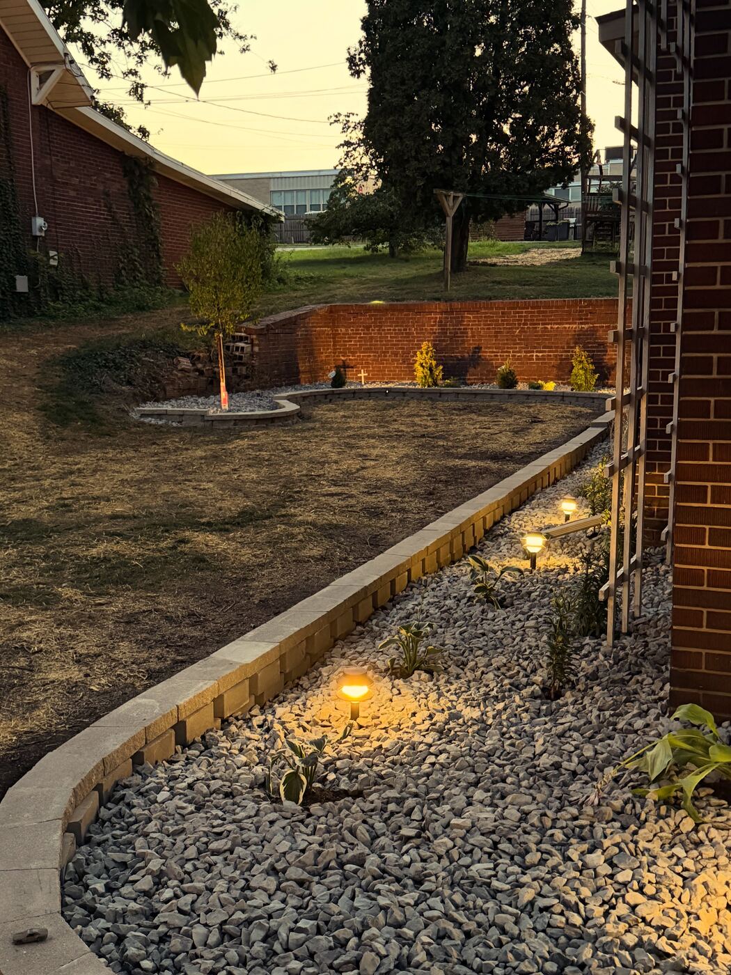 Landscape bed border with rock mulch and lighting